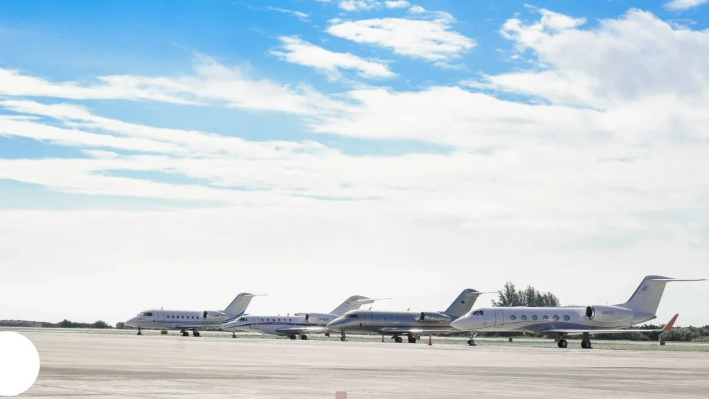 Private jets lined up on airport runway—CNC machining in precision aircraft manufacturing and aerospace technology.