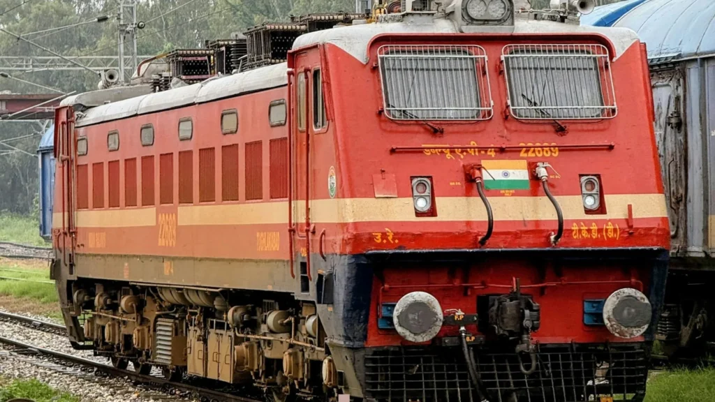 Red locomotive on railway tracks—CNC machining in rail transport equipment manufacturing and locomotive component precision