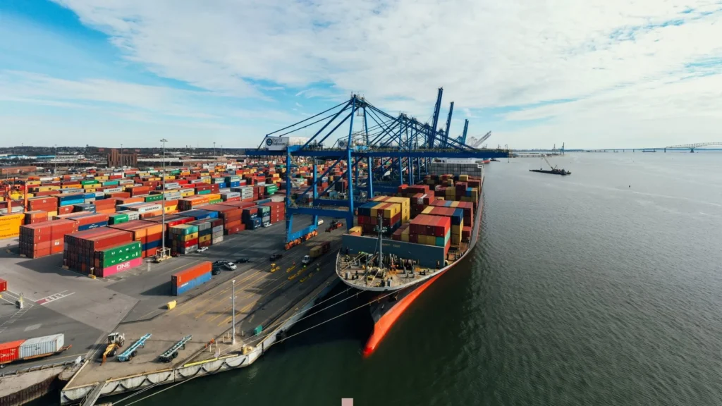 Container ship docked at busy seaport—illustrating CNC machining in logistics, shipping equipment, and port facility infrastructure