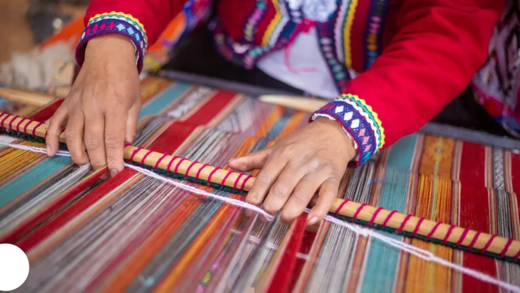 Hands weaving colorful fabric on traditional loom—CNC machining in textile equipment for precision garment and fabric manufacturing