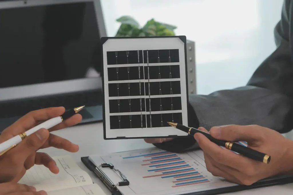 Close-up of solar panel model being explained during renewable energy consultation