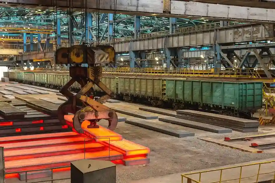 Industrial casting process with hot steel billets handled by crane in large-scale manufacturing plant