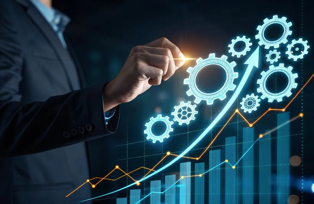 Business professional adjusting digital gears with an upward growth chart representing industrial manufacturing performance and operational improvement.